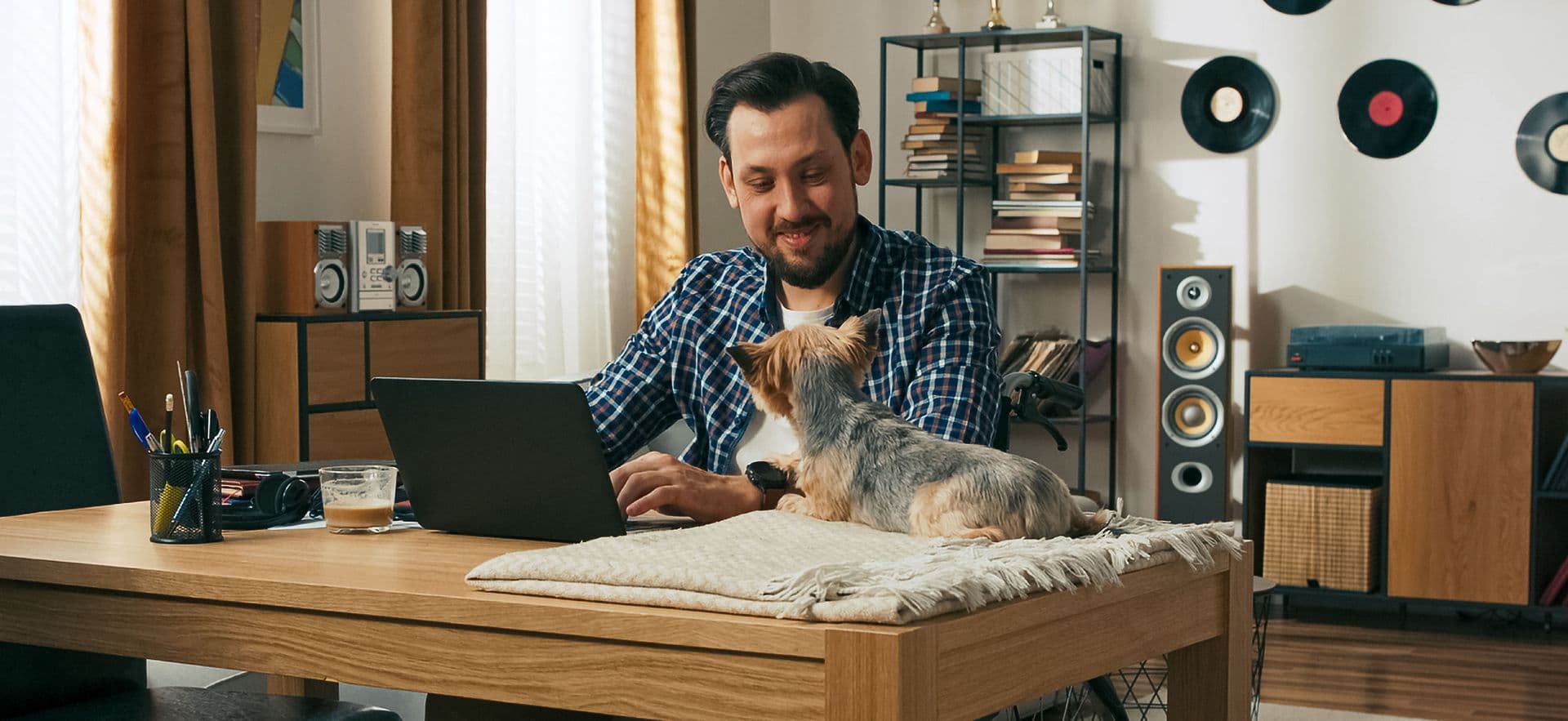 Person working at desk with their dog companion